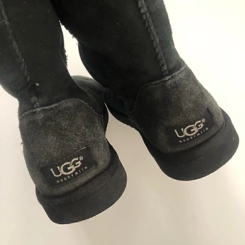 Ugg’s classic tall boots in black shearling lined